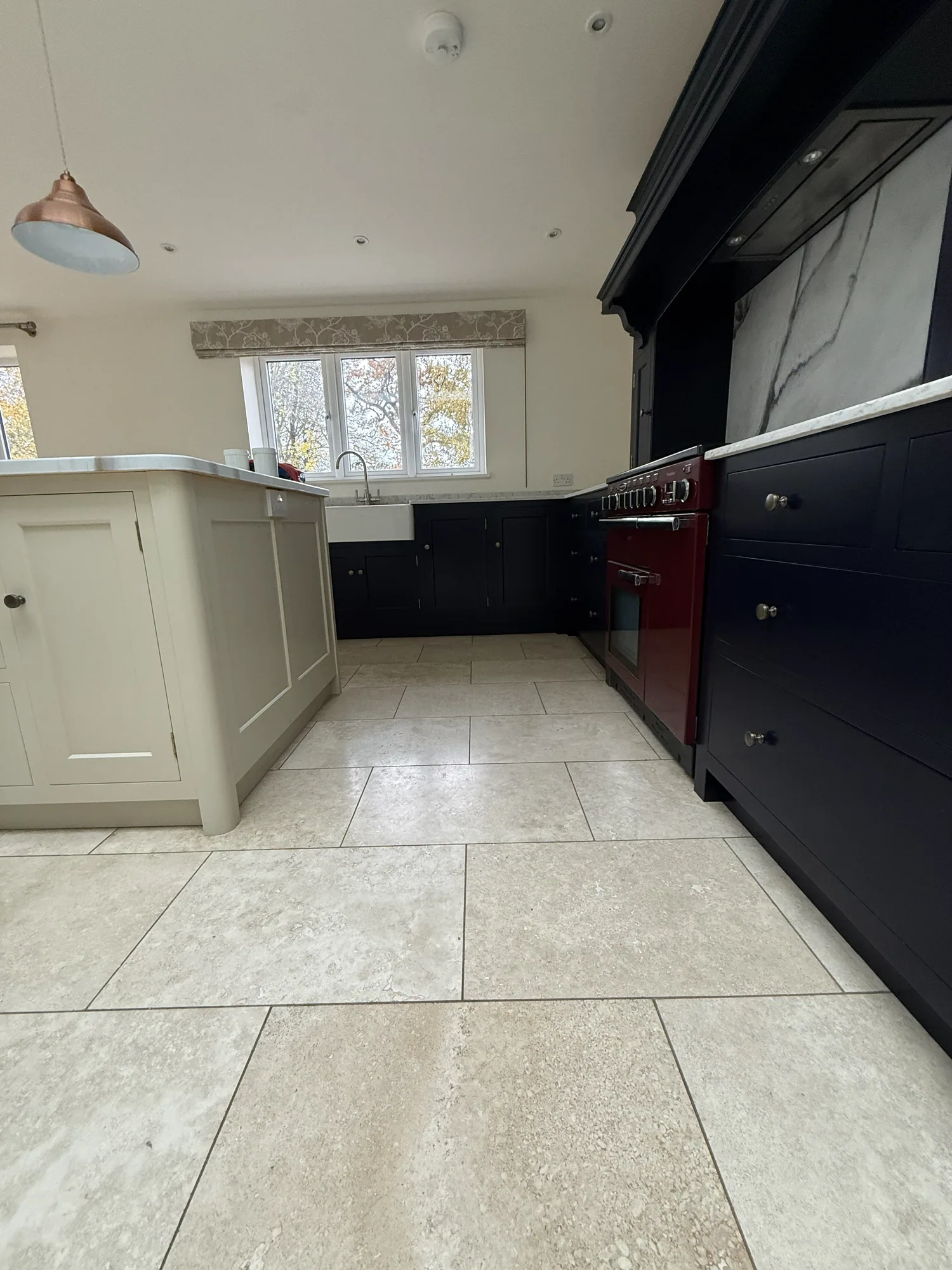 Navy kitchen with a red range cooker after respraying